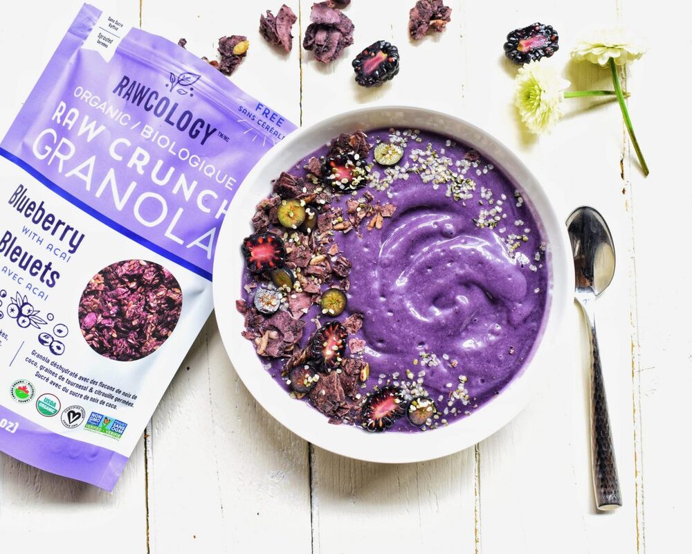 Purple smoothie bowl with Rawcology blueberry granola package